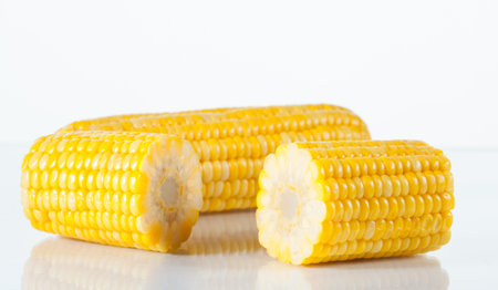 Boiled corn on white background with reflection