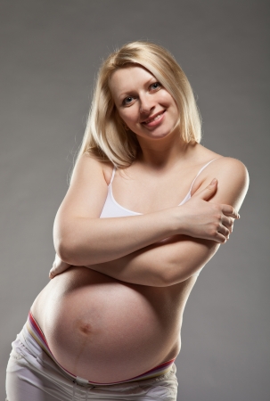 Happy pregnant woman; isolated on whiteの写真素材
