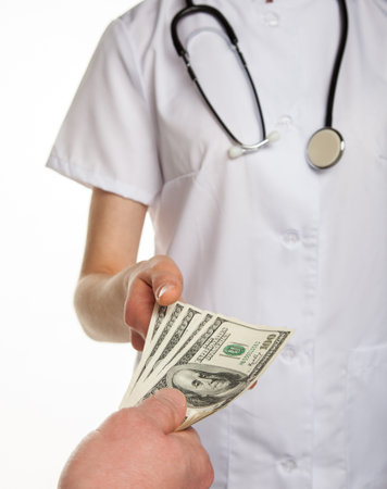 Patient paying medical service; isolated on white