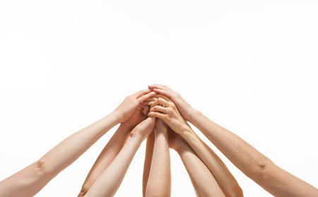 Successful team  many hands holding together on white backgroundの写真素材