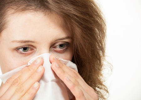 Woman holding handkerchief, isolated on white backgroundの写真素材