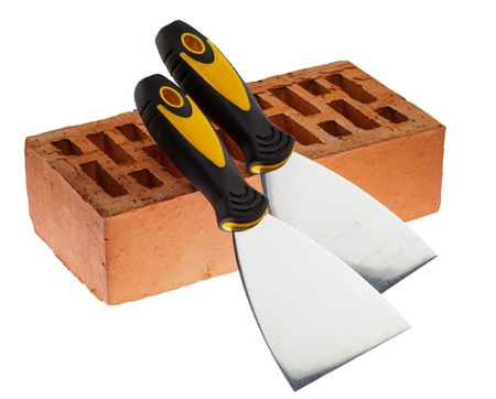 Plastering putty knives and a brick isolated over white backgroundの写真素材