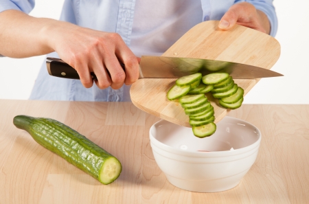 Salad preparation - cutting into pieces  fresh cucumberの写真素材