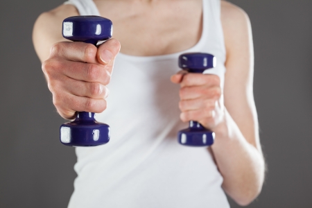 Woman doing fitness exercises with dumbbellsの写真素材