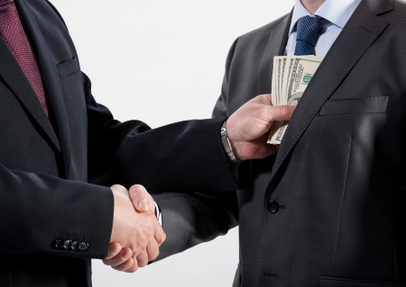 Giving a bribe into a pocket - closeup shotの写真素材
