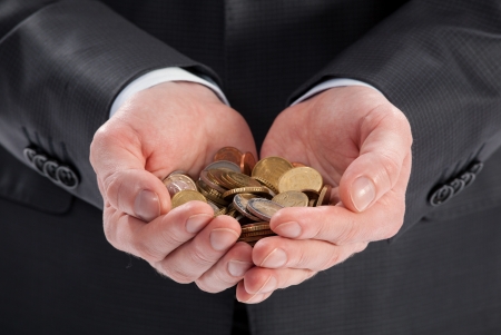 Businessman's hands holding coins, closeup shotの写真素材