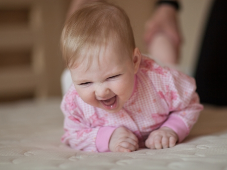 Portrait of a happy baby girl indoorsの写真素材