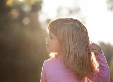 Portrait of smiling little girl outdoorsの写真素材