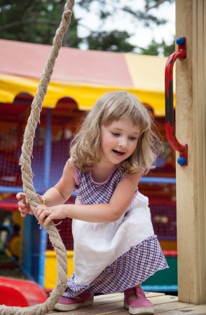 Active little girl playing with rope  in a stadium outdoorsの写真素材