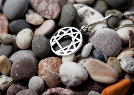 Silver symbol of enneagramma on pebbly backgroundの写真素材