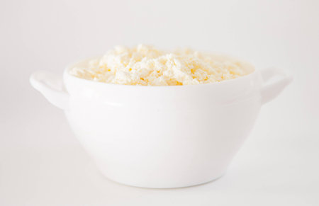 Fresh cottage cheese in a white bowlの写真素材