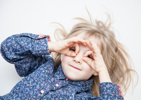 Portrait of a charming little girl on a white backgroundの写真素材