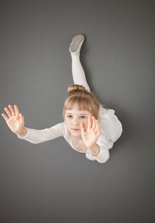 Graceful little ballerina, grey backgroundの写真素材