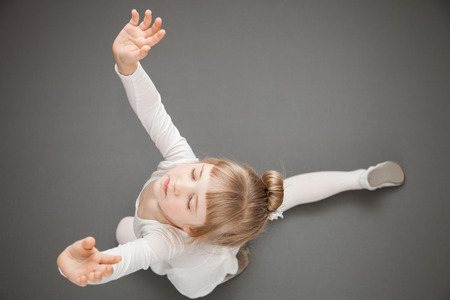 Graceful little ballerina, grey backgroundの写真素材