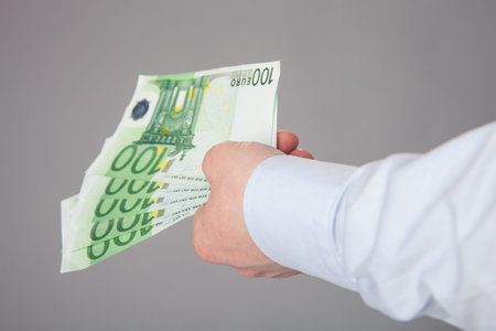Businessman's hand reaching out euro banknotes