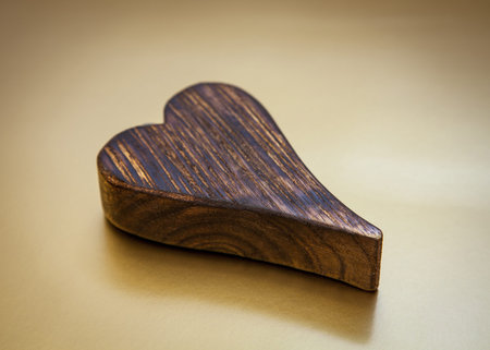 Wooden heart on yellow backgroundの写真素材