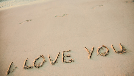Declaration of love: "I love you" drawn on sandの写真素材