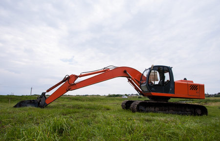 Excavator on a summer  fieldの写真素材