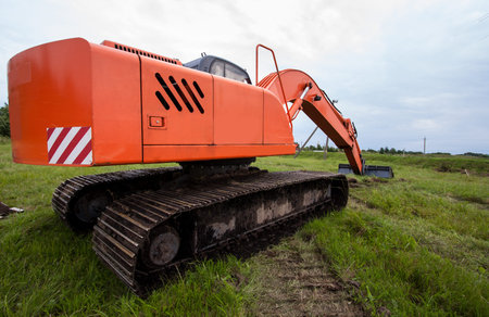 Excavator on a summer  fieldの写真素材