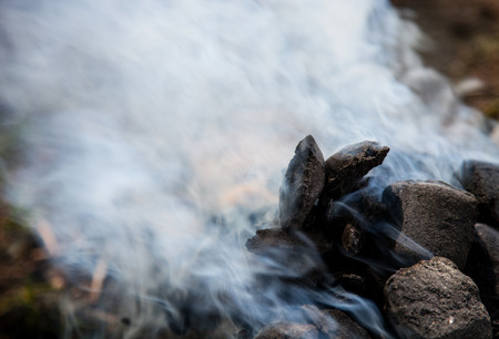 Fragment of a brome frome charcoal with dense smokeの写真素材