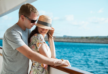 Young couple standing on board the shipの写真素材