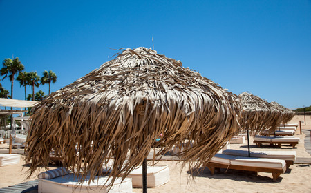 Empty sandy beach and beach beds - closeup shotの写真素材