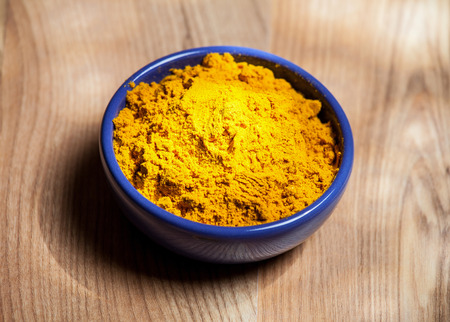 Saffron in the blue bowl, wooden backgroundの写真素材