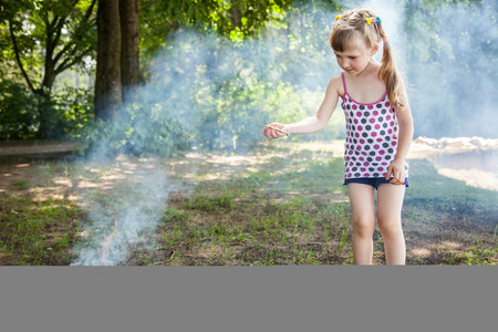 Pretty little girl near brome, natural green backgroundの写真素材