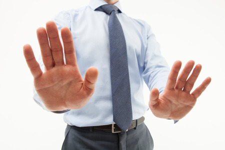Unrecognizable businessman  demonstrating a gesture of a rejection, white backgroundの写真素材