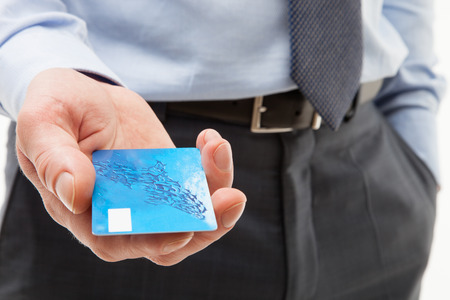 Businessman's hand giving credit card to you, closeup shotの写真素材