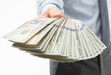 Man's hands holding dollar banknotes, closeup shot