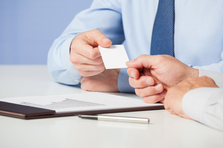 Businessman giving a visiting to partner, closeup shotの写真素材