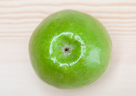 Green apple on wooden background