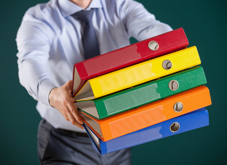 Businessman giving folders to you, closeup shot