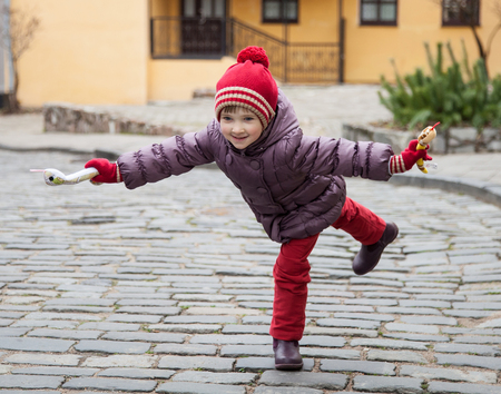 Smiling little girl walking outdoorsの写真素材