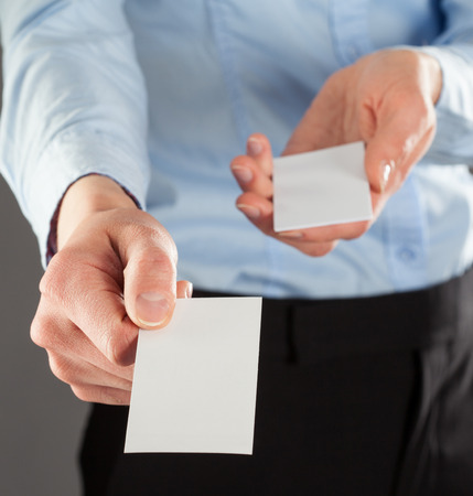 Businesswoman giving business card to you, you can add your text on itの写真素材
