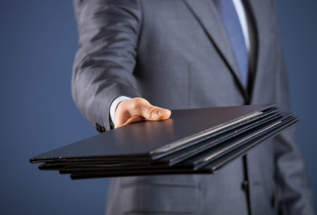 Businessman giving folders to you, closeup shot
