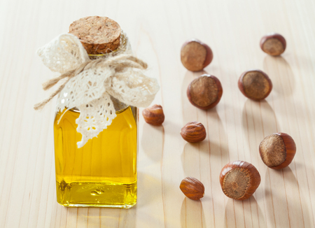 Healthy eating for beauty and energy! Nuts and natural oil on wooden tableの写真素材