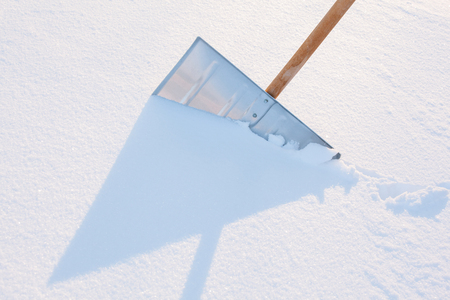 Snowshovel in the snowdrift - closeup shotの写真素材