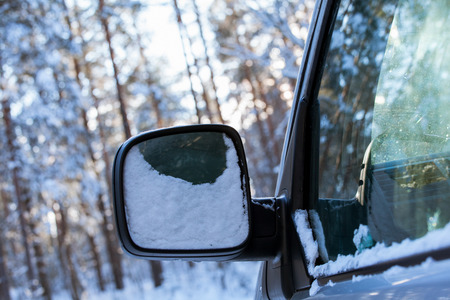 Fragment of a car in winter forest - closeup shotの写真素材