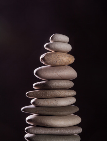 Pyramid from rocks on black backgroundの写真素材