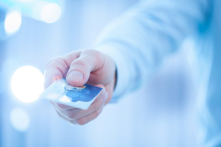 Businessman's hand giving credit card to you, closeup shotの写真素材