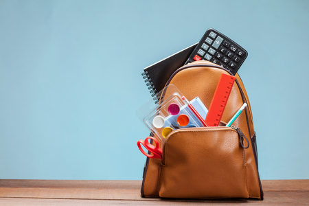 Backpack with clerical accessories, blue backgroundの写真素材