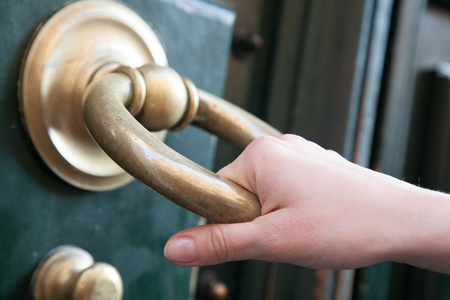 Human hand knocking old door, Italyの写真素材