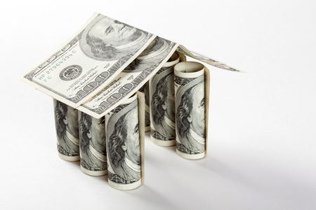 House made of dollar banknotes on white backgroundの写真素材