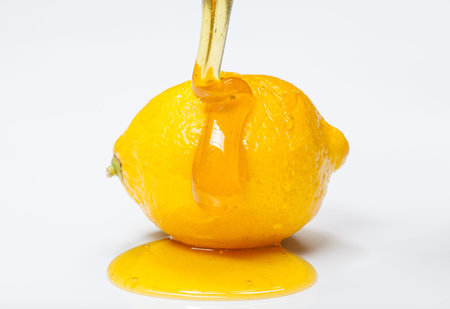 Lemon with honey on white backgroundの写真素材