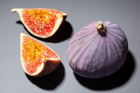 Fresh ripe figs on gray background