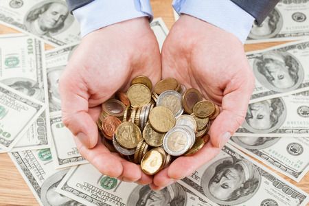 Businessman's hands holding many euro coins - closeup shotの写真素材