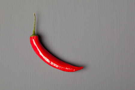 Red chili pepper on gray backgroundの写真素材