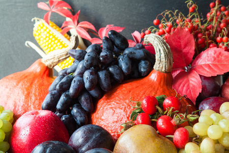 Composition of fresh raw fruits and vegetables on slate board backgroundの写真素材